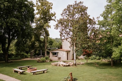 Salle de restaurant lumineuse avec tables en bois, chaises blanches, sol à carreaux et décoration élégante.