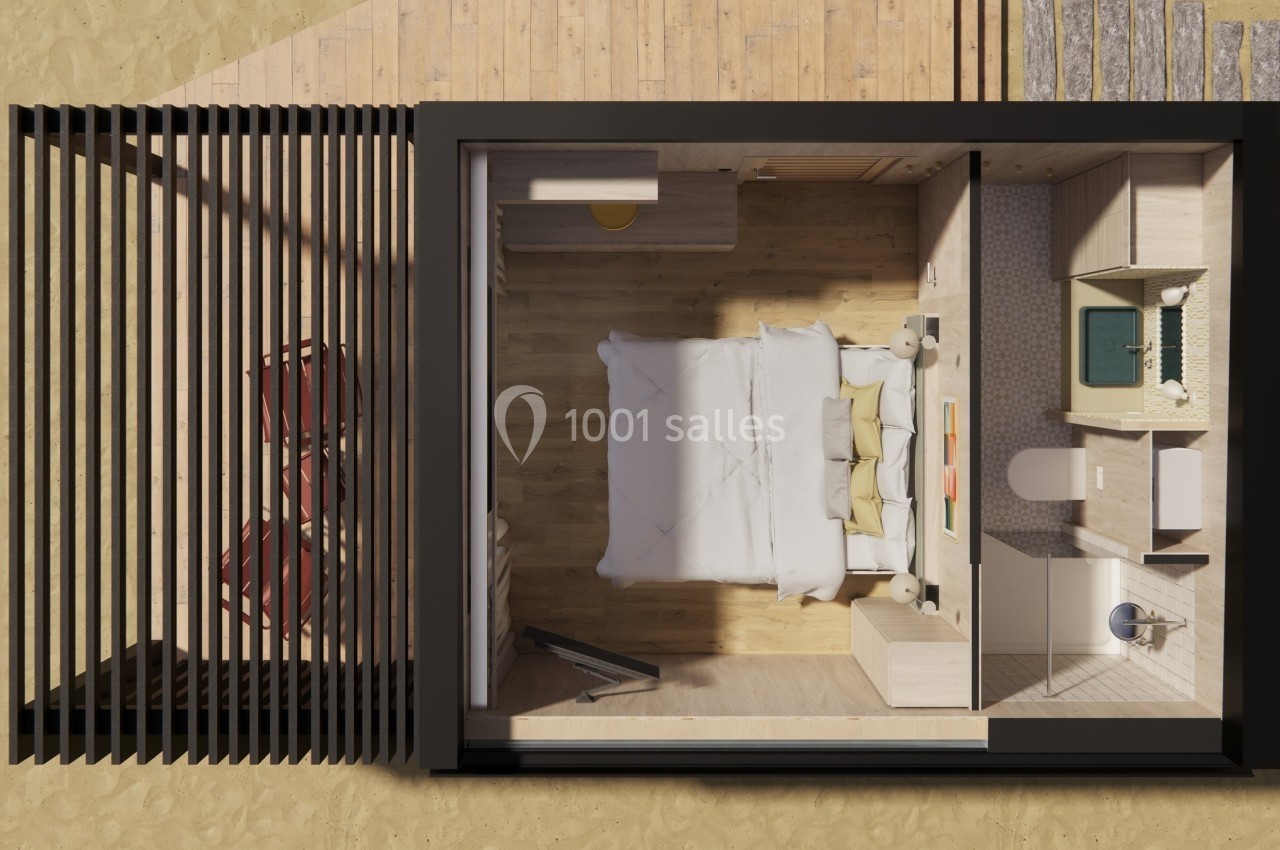 Vue aérienne d'une petite chambre moderne avec lit double, salle de bain attenante et mobilier intégré en bois clair.