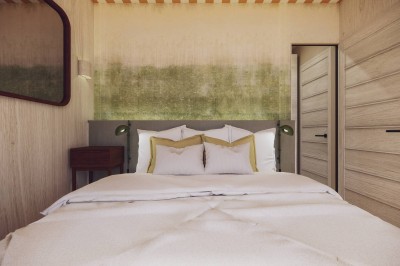 Vue aérienne d'une petite maison avec terrasse en bois, salon, chambre, salle de bain et environnement naturel autour.