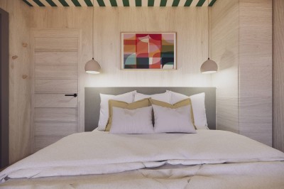 Vue aérienne d'une petite maison avec terrasse en bois, salon, chambre, salle de bain et environnement naturel autour.