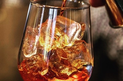 Dessert tiramisu en verrine avec une couche de cacao en poudre sur le dessus, posé sur une ardoise noire.