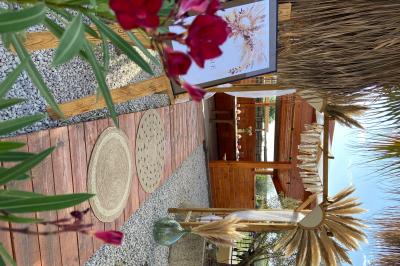 Table en bois garnie de divers plats, pains, charcuteries et amuse-bouches, présentés pour un buffet en extérieur.