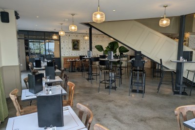 Poulet rôti garni de tranches d'oignon servi dans une assiette, une main utilise une fourchette pour le déguster.