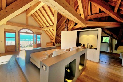 Table extérieure dressée avec des verres à vin, des fleurs, des bougies et des plateaux de nourriture.