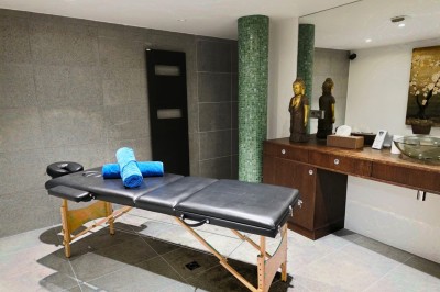 Table extérieure dressée avec des verres à vin, des fleurs, des bougies et des plateaux de nourriture.