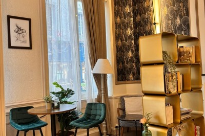 Miniature Location salle Bernay (Eure) - Hôtel du Lion d'Or #3 Chambre d'hôtel lumineuse avec lit double, linge blanc, décoration murale tropicale et cintres accrochés au mur.