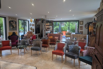 Batterie blanche installée sur une scène éclairée, entourée d'amplificateurs et de structures métalliques.