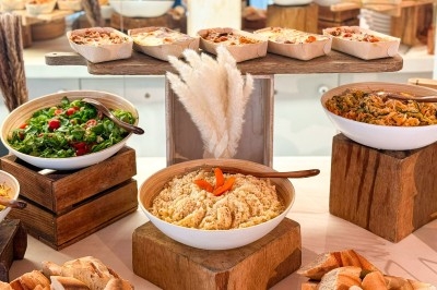 Bol de soupe verte garnie d'un œuf poché, de croûtons et d'une herbe fraîche, posé sur une table en marbre vert.