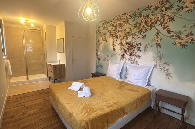 Miniature une chambre dans le gîte tour Est Un couple en tenue de mariage marche dans une salle en briques, avec un bouquet de fleurs au premier plan.