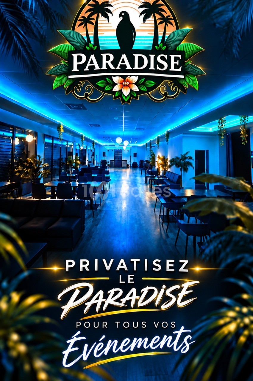 Salle intérieure éclairée en bleu avec tables basses, chaises noires, plantes vertes et logo Paradise au plafond.