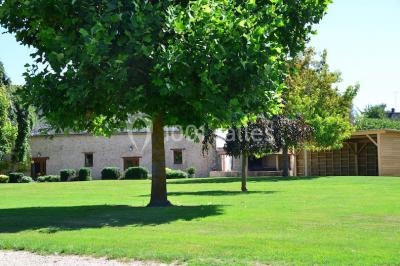 Salle de réception décorée avec des tables dressées, des guirlandes lumineuses et des voilages suspendus au plafond.