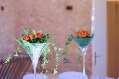 Salle de réception décorée avec des tables dressées, des guirlandes lumineuses et des voilages suspendus au plafond.