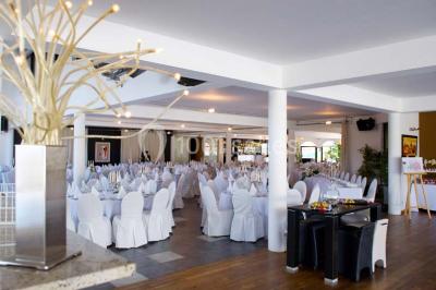 Vue d'une maison moderne avec piscine, statue décorative au premier plan et ciel dégagé en arrière-plan.