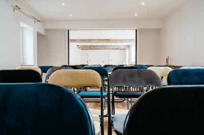 Plaque ’Château de Champvallins’ sur une table en rotin avec une cloche dorée et une boîte décorative.