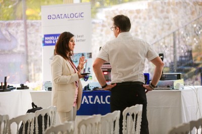 Des échantillons de boissons, badges et sacs promotionnels disposés sur une table lors d'un événement.