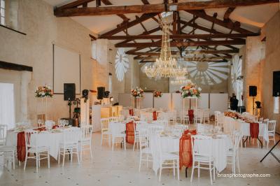Miniature Location salle Granzay-Gript (Deux-Sèvres) - Château La Bone #3 Un couple de mariés s'embrasse devant une voiture ancienne stationnée dans une cour ensoleillée.