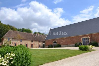 Chambre avec un lit double, un lit simple, deux lampes de chevet allumées et une fenêtre avec rideaux gris.