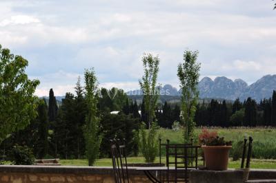 Colonne en pierre sur un socle dans un parc arboré, entourée de pelouse et d'arbres feuillus.