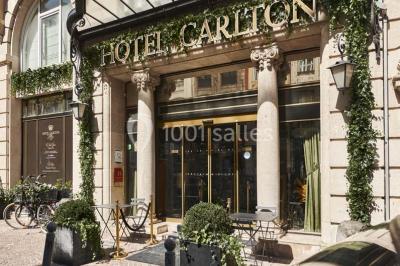 Un homme court sur un tapis de course dans un spa, une femme en peignoir est assise en arrière-plan.