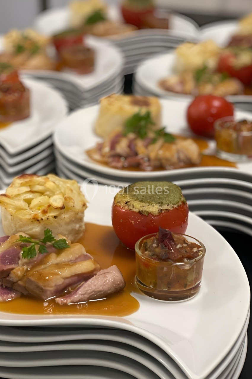 Assiette gastronomique composée de viande en sauce, légumes farcis, gratin individuel et accompagnements variés.