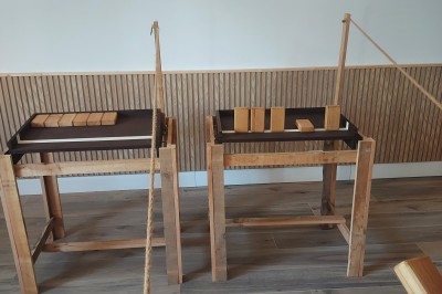 Salle de réception avec une table ronde décorée, des ballons et une grande table dressée en arrière-plan.