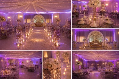 Salle de réception décorée avec des lumières tamisées, des fleurs blanches et des tables élégantes sous un plafond illuminé.