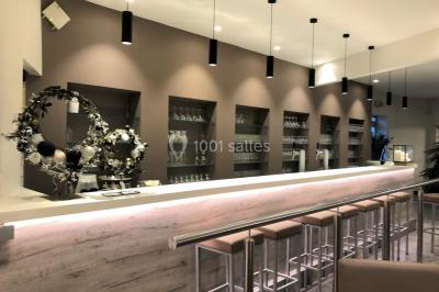 Structure de jeux en plein air avec toboggan et modules d'escalade, installée sur un sol sablonneux près d'une clôture.