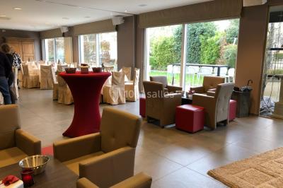 Structure de jeux en plein air avec toboggan et modules d'escalade, installée sur un sol sablonneux près d'une clôture.