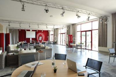 Miniature Location salle Bélesta (Pyrénées-Orientales) - Domaine Riberach #9 Bain à remous éclairé en bleu, entouré de pierres sombres, avec un panier de pétales rouges au premier plan.