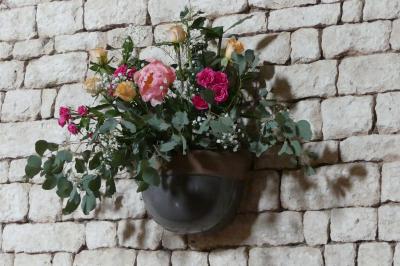 Un couple marche dans le jardin d'un château ancien entouré de verdure par une journée ensoleillée.