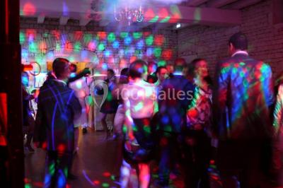 Un couple marche dans le jardin d'un château ancien entouré de verdure par une journée ensoleillée.