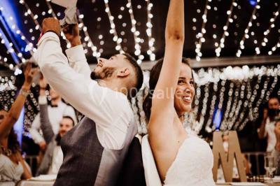 Des femmes en tenue élégante trinquent avec des verres à pied, vues en contre-plongée depuis le centre du cercle.